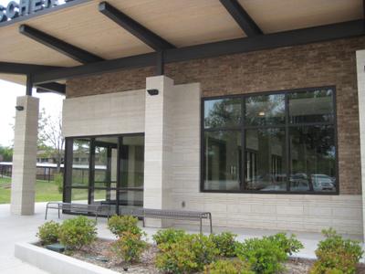 Campus courtyard view showing brick facade with stone window surrounds