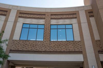 Main entrance canopy with brick columns and accent banding