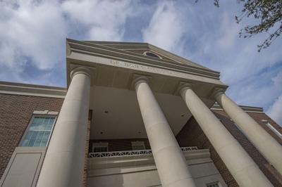 Corner tower element with decorative brick corbeling and limestone trim