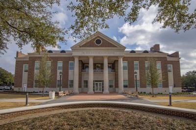 Main entrance portico with brick columns and arched header