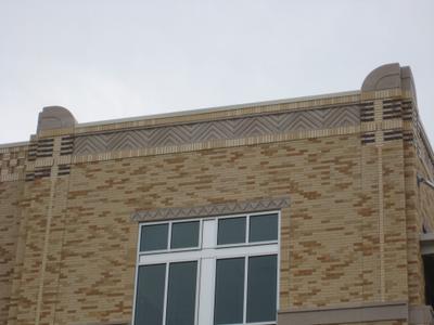 Main entrance with natural stone columns and TCU branding