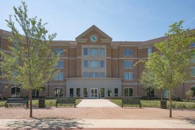 Main entrance featuring brick columns and university signage